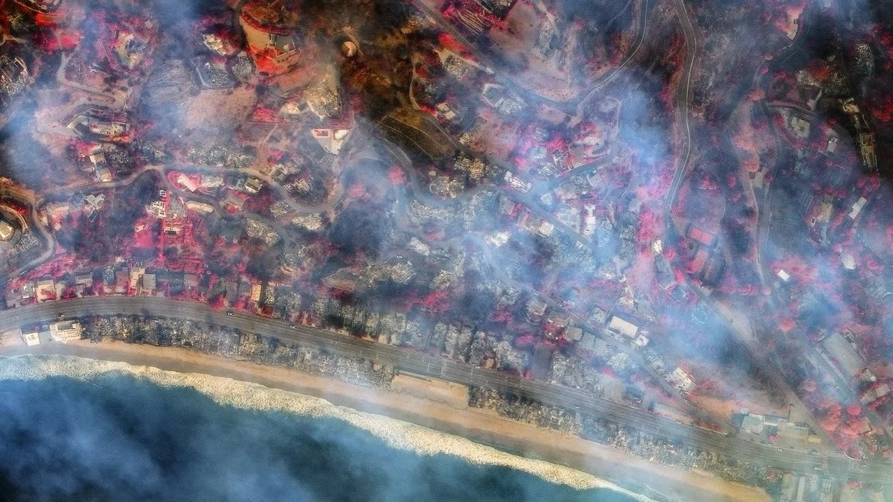Aerial view of Malibu after wildfire - smoke, burnt homes, devastation
